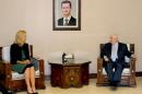 Syrian Foreign Minister Walid Muallem (R) meeting with Special Coordinator of the Organisation for the Prohibition of Chemical Weapons (OPCW)-United Nations Joint Mission, Sigrid Kaag in Damascus on October 22, 2014