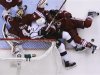Los Angeles Kings' Nolan and Phoenix Coyotes' Morris battle for the puck while sliding into Coyotes' Smith during Game 2 of the NHL Western Conference hockey finals in Glendale.