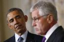 U.S. President Obama listens to Defense Secretary Chuck Hagel after the president announced Hagel's resignation at the White House in Washington