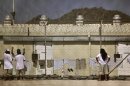 Detainees talk together inside the open-air yard at the Camp 4 detention facility at Guantanamo Bay U.S. Naval Base in Cuba