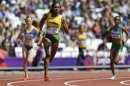 Jamaica's Novlene Williams-Mills, front, starts a women's 400-meter heat at the 2012 Summer Olympics in London Friday, Aug. 3, 2012. (AP Photo/Ben Curtis)