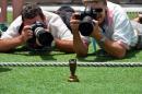 Photographers take pictures of the Ashes Urn at the Gabba in Brisbane on November 20, 2013 on the eve of the first Ashes cricket Test match between England and Australia
