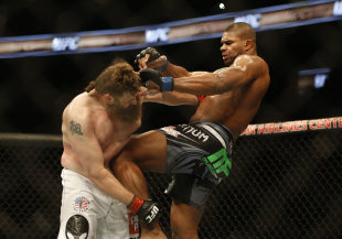 Alistair Overeem knees Roy Nelson in the stomach during their fight on Saturday. (USAT)