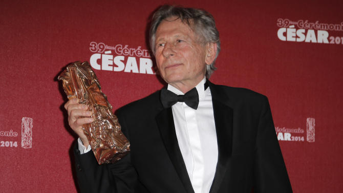 FILE - In this Feb. 28, 2014 file photo Polish-French film director Roman Polanski holds his best director award during the 39th French Cesar Awards Ceremony in Paris, Friday Feb. 28, 2014. Prosecutors in Poland questioned filmmaker Roman Polanski on the request of U.S. prosecutors who are seeking his arrest on charges from 1977 of having sex with a minor, a spokeswoman said Thursday, Oct. 30, 2014. Spokeswoman for the prosecutors in Krakow, Boguslawa Marcinkowska, said the filmmaker remained free but available for further proceedings. (AP Photo/Lionel Cironneau, File)