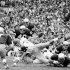 FILE - In this Oct. 27, 1973, file photo, Notre Dame's Greg Collins, bottom right, tries to make the tackle as Southern California's Anthony Davis reaches for a 4-yard gain during the first quarter of their NCAA college football game in South Bend, Ind. Notre Dame's Tim Rudnick (7), Gary Potempa (40), Ross Browner (89) and Mike Fanning (88) help on the play. Three field goals by Bob Thomas, an 85-yard touchdown run by Eric Penick and stingy run defense helped Notre Dame end Southern California's winning streak at 23 games with a 23-14 victory. The Associated Press takes a look at some of the memorable games in college football's greatest intersectional rivalry in anticipation of Southern California hosting No. 1 Notre Dame on Saturday, Nov. 24, 2012. (AP Photo/Charles Knoblock, File)