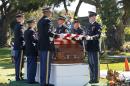 A military honor guard drapes a U.S. flag over the coffin of Army Sgt. Lee H. Manning at the Inglewood Park Cemetery in Inglewood, Calif on Friday, Nov. 7, 2014. Manning, who died as a POW during the Korean War and whose remains were recently identified, was finally laid to rest receiving full military honors. Manning was just 20 years old when he enlisted in 1950 and trained as a medic. Returning POWs reported Manning was captured by Chinese forces during a 1950 battle and died six months later from medical neglect. (AP Photo/Nick Ut)