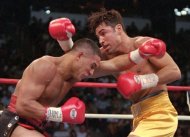 FILE - This Sept. 13, 1997 file photo shows Hector Camacho, left, of Puerto Rico, and Oscar De La Hoya of Los Angeles exchanging blows in the first round of their WBC welterweight championship in Las Vegas. Police in the Puerto Rican city of Bayamon say they found drugs inside the car in which former champion boxer Camacho was shot and critically wounded. Camacho was in critical condition Wednesday, Nov. 21, 2012, at the Centro Medico trauma center in San Juan.  (AP Photo/Mike Salsbury, File)