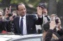 New French President Francois Hollande waves out of a sunroof as he rode up the Champ-Elysses avenue after the presidential handover ceremony, Tuesday, May 15, 2012 in Paris. Hollande became president of France on Tuesday in a ceremony steeped in tradition, taking over a country with deep debts and worried about Europe's future and pledging to make it a fairer place. (AP Photo/Michel Euler)