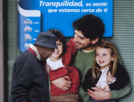 <p> A man walks past a poster in a bank window showing a smiling family with a message reading 'Tranquility is to feel that we are close to you' in Madrid, Spain, Friday April 26, 2013. The Spanish Government is to announce new round of reforms Friday that could include new cutbacks to meet deficit target.(AP Photo/Paul White)