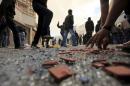 File photo of rioters throwing stones during clashes with riot police in Tunis