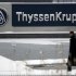 A man walks past a logo of Germany's industrial conglomerate ThyssenKrupp AGat their headquarters in Essen
