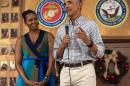 US President Barack Obama addresses troops with First Lady Michelle Obama at Marine Corps Base Hawaii in Kailua