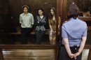 Tolokonnikova, Samutsevich and Alyokhina, members of female punk band "Pussy Riot", attend their trial inside the defendents' cell in a court in Moscow