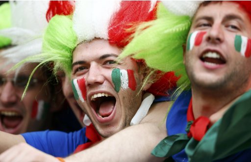 Italian fans with their faces painted cheer as they wait for the start of the Group C Euro 2012 soccer match against Spain in PGE Arena in Gdansk