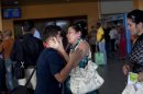 Ivan Lee, 12, says goodbye to a family member before traveling to Miami, Florida, where he will reunite with his mother who has been living there for years, as he prepares to board a plane at the Jose Marti International Airport in Havana, Cuba, Monday, Jan. 14, 2013. Cubans formed long lines outside travel agencies and migration offices on Monday, as a highly anticipated new law took effect ending the island's much-hated exit visa requirement. The new law also extends the amount of time Cubans can remain abroad without loosing their Cuban citizenship. Before the law, Cubans had to return within 11 months, but now can remain 24 months abroad, and are eligible for extensions. (AP Photo/Ramon Espinosa)