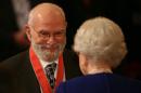 FILE - This is a Nov. 26, 2008 file photo of Dr Oliver Sacks, receiving his Commander of the Order of the British Empire (CBE ), by Britain's Queen Elizabeth II at Buckingham Palace, London. Dr. Oliver Sacks, whose books like "The Man Who Mistook His Wife For a Hat" probed distant ranges of human experience by compassionately portraying people with severe and sometimes bizarre neurological conditions, has died. He was 82 .Sacks died Sunday at his home in New York City, his assistant, Kate Edgar, said. (Lewis Whyld/PA via AP) UNITED KINGDOM OUT