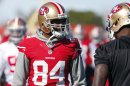 San Francisco 49ers wide receiver Randy Moss talks with a teammate during a NFL Super Bowl XLVII football practice in New Orleans
