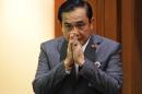 Thailand's Prime Minister Prayuth Chan-ocha gestures in a traditional greeting before reading out his government's policy at the Parliament in Bangkok