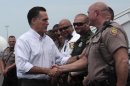 Republican presidential candidate, former Massachusetts Gov. Mitt Romney greets highway patrol officers before boarding the campaign charter flight, Monday, Aug. 13, 2012, in St. Augustine, Fla. (AP Photo/Mary Altaffer)