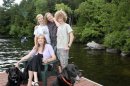 Writer Jennifer Finney Boylan sits with her spouse Deidre and their sons Zach and Sean outside their lake house in Maine