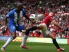 Manchester United's Buttner challenges Wigan Athletic's Boyce during their English Premier League soccer match in Manchester