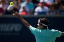 Roger Federer of Switzerland serves to Jo-Wilfried Tsonga of France in the final of the Rogers Cup at Rexall Centre in Toronto, Ontario, August 10, 2014