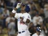 Los Angeles Dodgers' Yasiel Puig celebrates as he crosses home plate after hitting a two-run home run during the sixth inning of their baseball game against the San Diego Padres, Tuesday, June 4, 2013, in Los Angeles. (AP Photo/Jason Redmond)