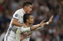 Real Madrid's James Rodriguez jumps on Real Madrid's Cristiano Ronaldo's back after Ronaldo scored his side's first goal during a Champions League, Group F soccer match between Real Madrid and Sporting, at the Santiago Bernabeu stadium in Madrid, Spain, Wednesday, Sept. 14, 2016. (AP Photo/Daniel Ochoa de Olza)