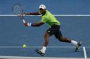 Donald Young of the United States plays a return to Kei Nishikori of Japan during their men's singles match at the Australian Open 2014 tennis tournament in Melbourne