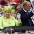 Britain's Queen Elizabeth waves to members of the public as she and her husband Prince Philip drive through the Stormont estate in Belfast, Northern Ireland