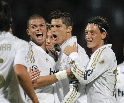 Ronaldo of Real Madrid celebrates with team mates after scoring against Olympique Lyon during their Champions League soccer match at the Gerland stadium