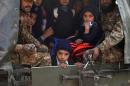 Pakistani soldiers transport rescued schoolchildren from the site of an attack by Taliban gunmen on a school in Peshawar, on December 16, 2014