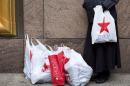 File photo of a shopper standing with her bags outside Macy's department store in New York