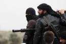 Fighters of the jihadist group Al-Nusra Front stand on the top of a pick-up mounted with a machine gun on April 4, 2013 in the Syrian village of Aziza, on the southern outskirts of Aleppo