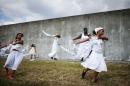 Performers from 'Gallery of the Streets' dance along the repaired levee wall in the Lower Ninth Ward during a ceremony marking the 10th anniversary of Hurricane Katrina on August 29, 2015 in New Orleans, Louisiana