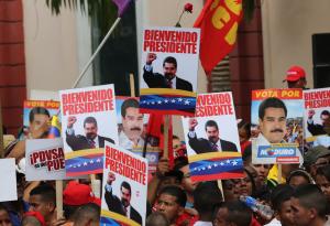 Supporters hold placards with images of Venezuela&#39;s&nbsp;&hellip;