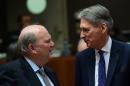 Ireland's Finance Minister Michael Noonan (L) and UK Finance Minister Philip Hammond talks as they attend an Economic and Financial Affairs Council meeting at the European Council, in Brussels, on December 6, 2016