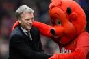 Manchester United's Scottish manager David Moyes (L) shakes hands with mascot Fred the Red ahead of the English FA Cup third round football match between Manchester United and Swansea City at Old Trafford in Manchester on January 5, 2014