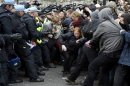 Supporters of a Unite Against Fascism (UAF) counter-demonstration scuffle with police in London