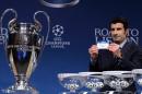 Former Portugal international footballer and UEFA Champions League Final Ambassador Luis Figo holds up the name of Barcelona during the draw for the Champions League last 16 at the UEFA headquarters in Nyon, Switzerland on December 16, 2013