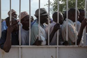 Men wait as women queue to receive humanitarian aid …