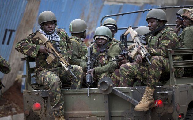 Trucks of soldiers from the Kenya Defense Forces arrive after dawn outside the Westgate Mall in Nairobi, Kenya Sunday, Sept. 22, 2013. Islamic extremist gunmen lobbed grenades and fired assault rifles inside Nairobi's top mall Saturday, killing dozens and wounding over a hundred in the attack. Early Sunday morning, 12 hours after the attack began, gunmen remained holed up inside the mall with an unknown number of hostages. (AP Photo/Ben Curtis)