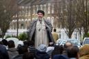 Imam Abu Hamza addresses followers during Friday prayer in near Finsbury Park mosque in north London, on March 26, 2004