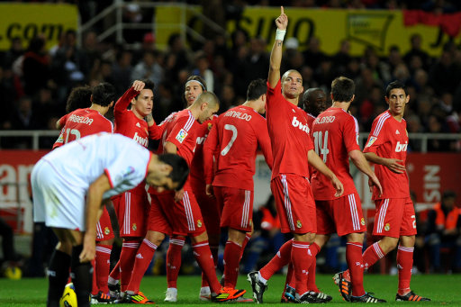 Real Madrid's players celebrate a goal during their Spanish league football match Sevilla FC vs Real Madrid on December 17, 2011 at Ramon Sanchez Pizjuan stadium in Sevilla. Real Madrid won 6-2. AFP PHOTO/ JORGE GUERRERO (Photo credit should read Jorge Guerrero/AFP/Getty Images)