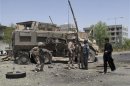 NATO soldiers with the International Security Assistance Force stand at the site of an attack in Helmand province