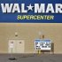 A man stands on a skateboard outside a Wal-Mart store in Williston, North Dakota