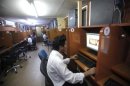 A man looks youtube at a internet cafe in Yangon