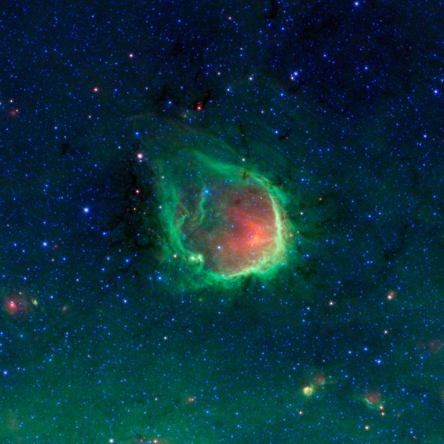 This glowing emerald nebula seen by NASA's Spitzer Space Telescope is named RCW 120; it is about 4,300 light-years away in the tail of the constellation Scorpius. The false-color image was created by 