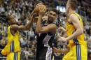 San Antonio Spurs' Tim Duncan, center, and ALBA's Alex Renfroe from the US, left, and Leon Radosevic from Kroatien, right, challenge for the ball during an NBA Global Games basketball match between US team San Antonio Spurs and German team ALBA Berlin in Berlin, Germany, Wednesday, Oct. 8, 2014. (AP Photo/Michael Sohn)