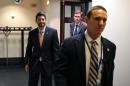 House Speaker Paul Ryan of Wis., left, departs after a Republican caucus meeting on Capitol Hill, Tuesday, Dec. 15, 2015 in Washington. (AP Photo/Alex Brandon)
